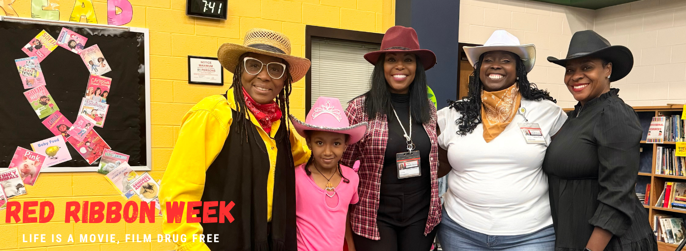 3 women and 1 girl posing for a picture in the library; red ribbon week. life is a movie, film drug free.